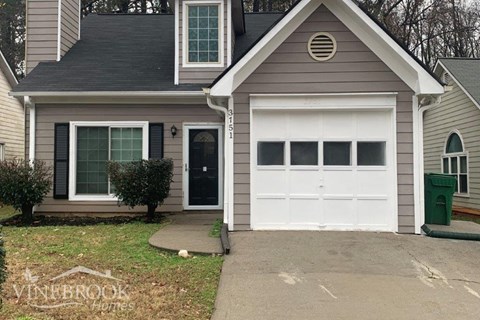 a white garage door in front of a house